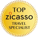 A gold circular badge featuring the text "Top Zicasso Travel Specialist" in black and red letters.